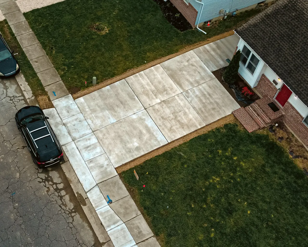 Aerial view of a concrete driveway in front of a residential home in Delaware