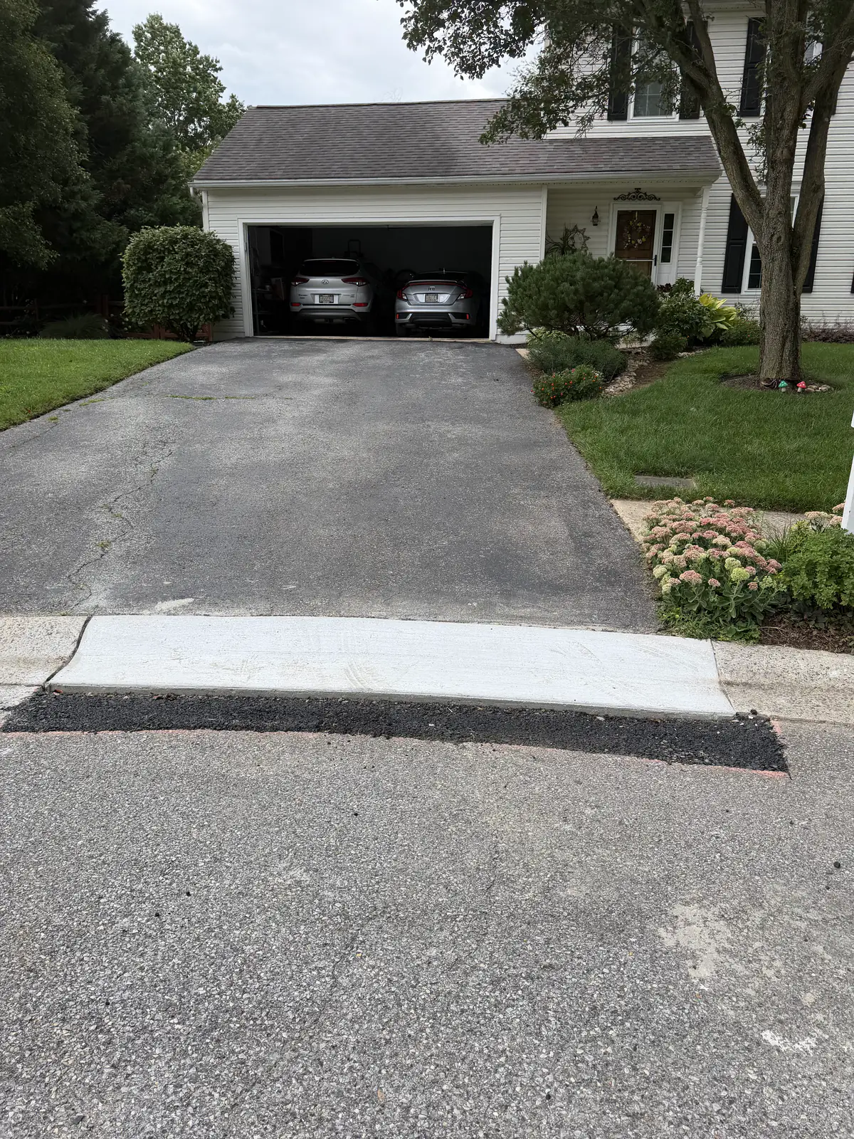 New concrete driveway apron tying a residential driveway into the street in New Castle County, DE