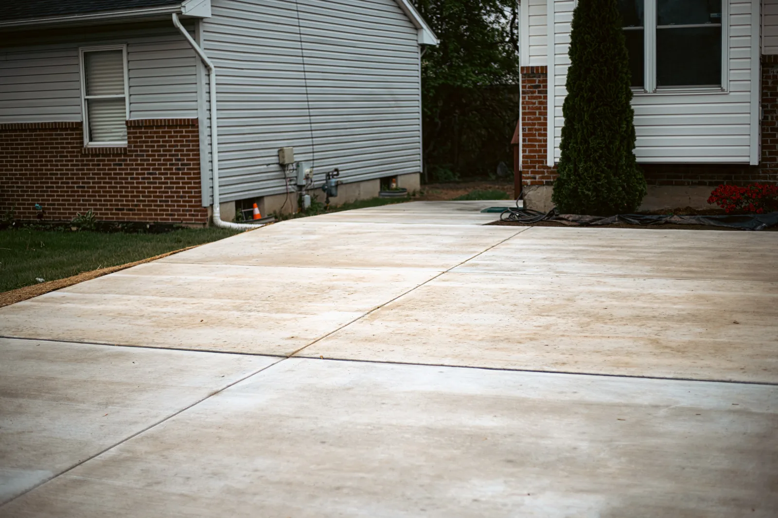 Freshly poured curved concrete driveway in a New Castle County, DE neighborhood