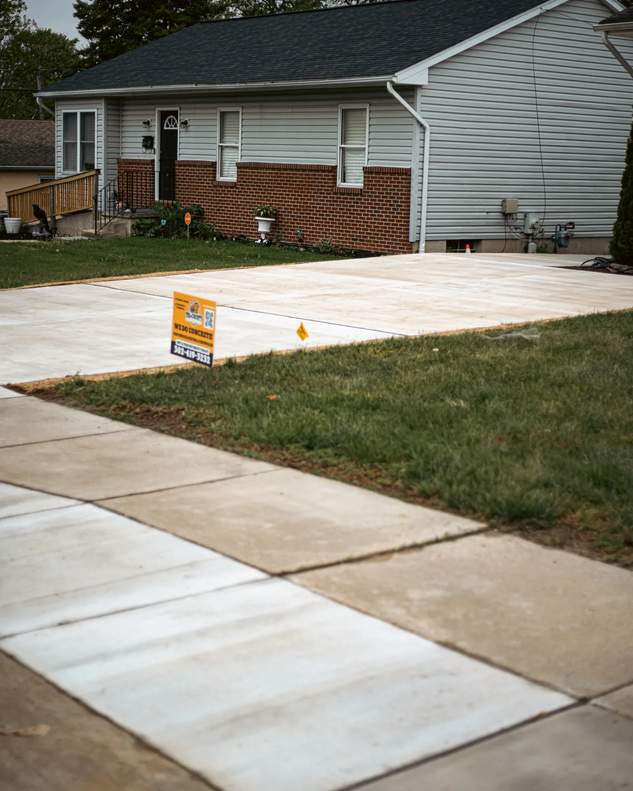 New concrete driveway approach to a residential home in New Castle County, DE