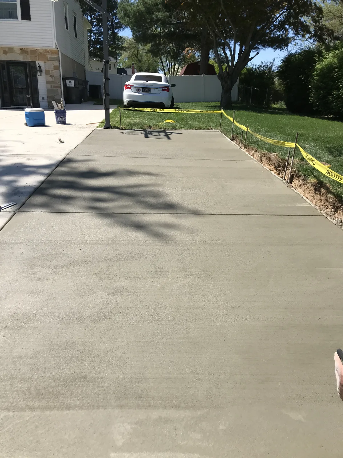 Wide concrete driveway with parked car in New Castle County, DE