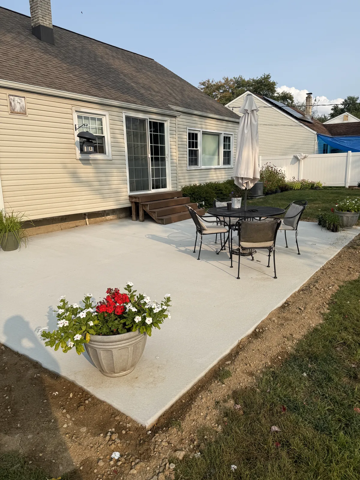 Finished concrete patio with outdoor furniture in a Newark, DE backyard