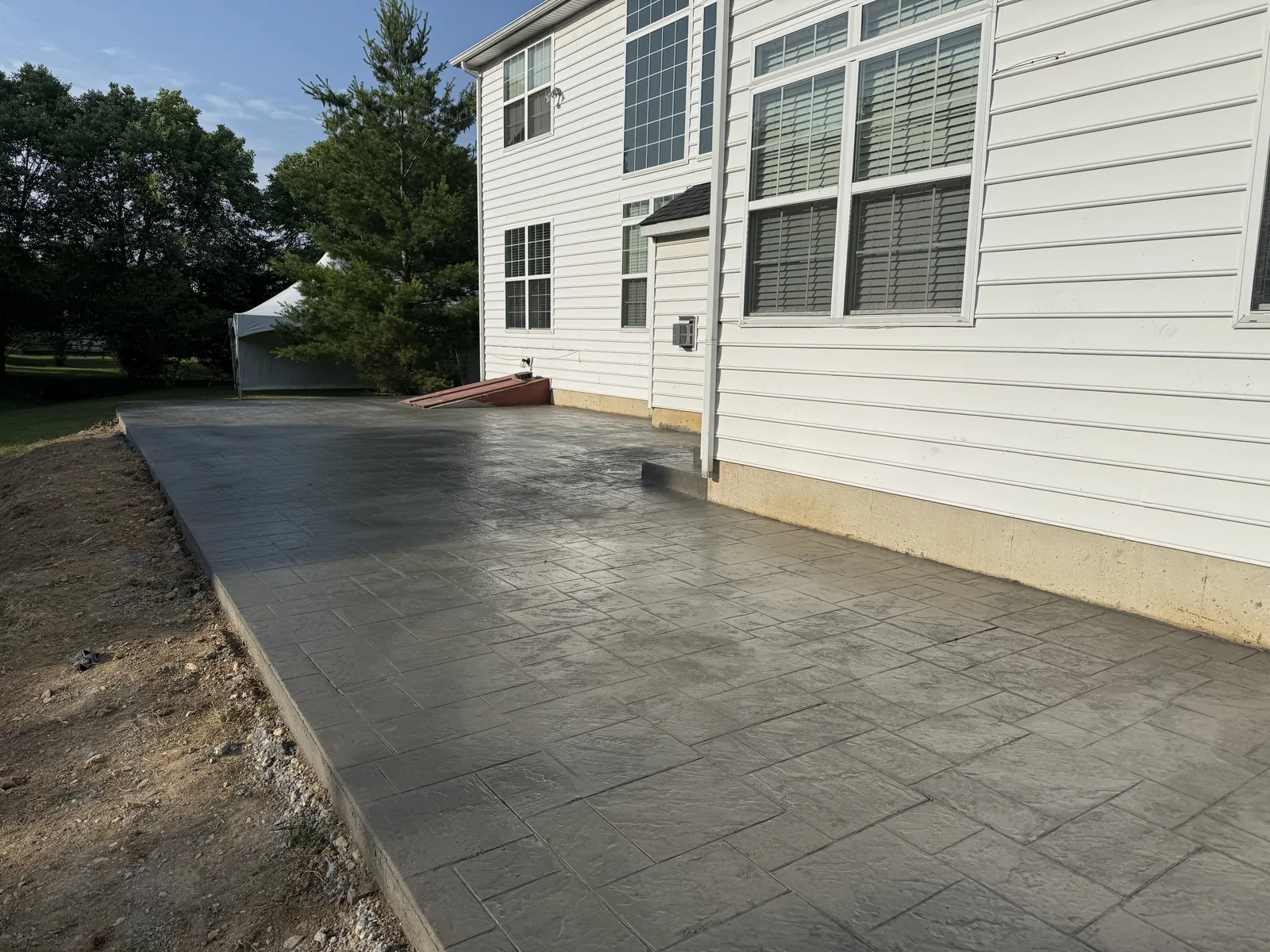 Spacious poured concrete patio behind a home in New Castle County, DE