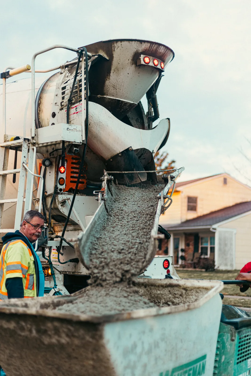 Concrete truck loading a power buggy during a pour in New Castle County, DE
