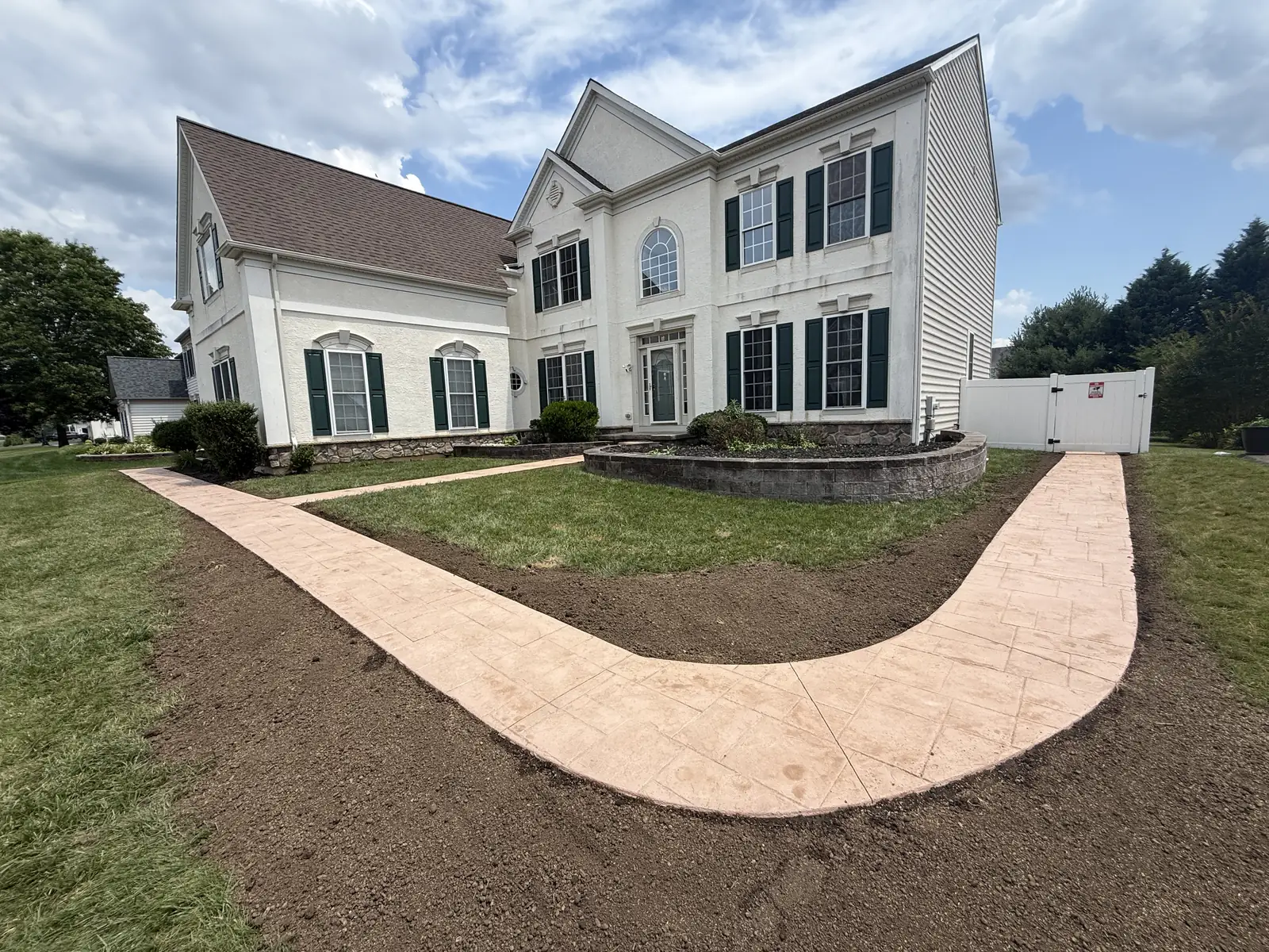 Curved concrete walkway through a front yard in New Castle County, DE