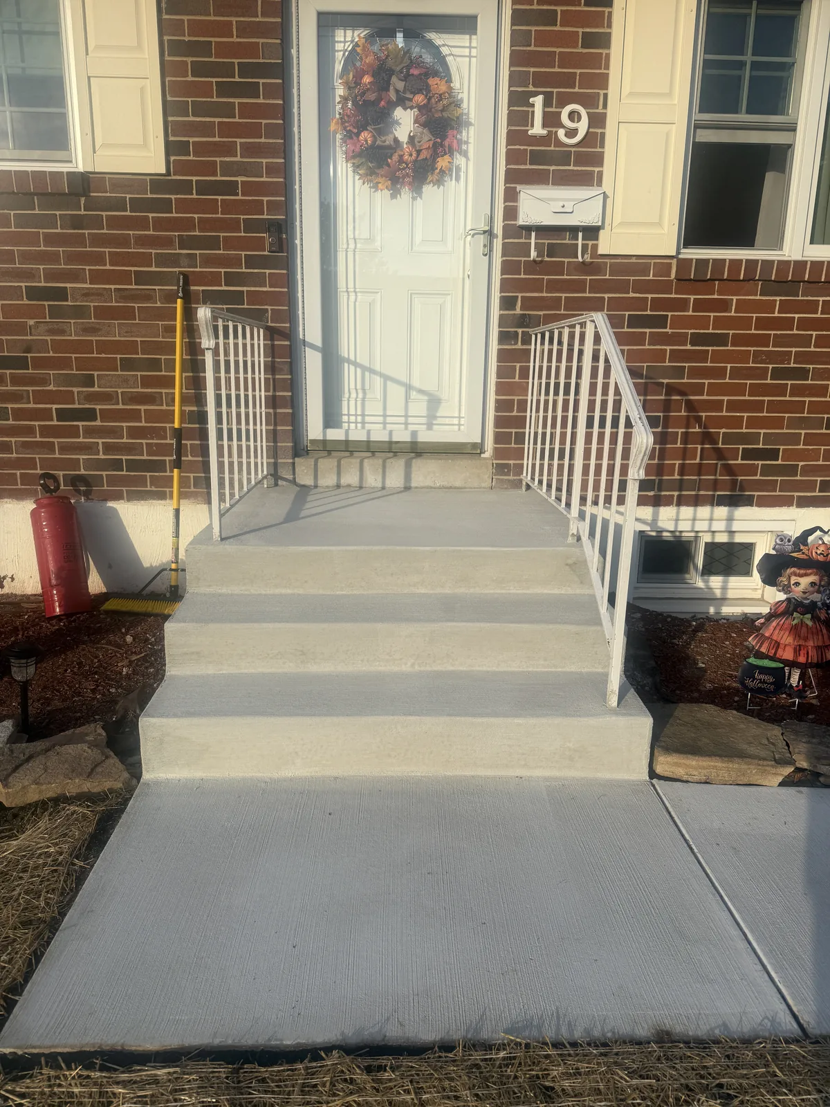 Concrete walkway and steps at a brick home's front entry in New Castle County, DE