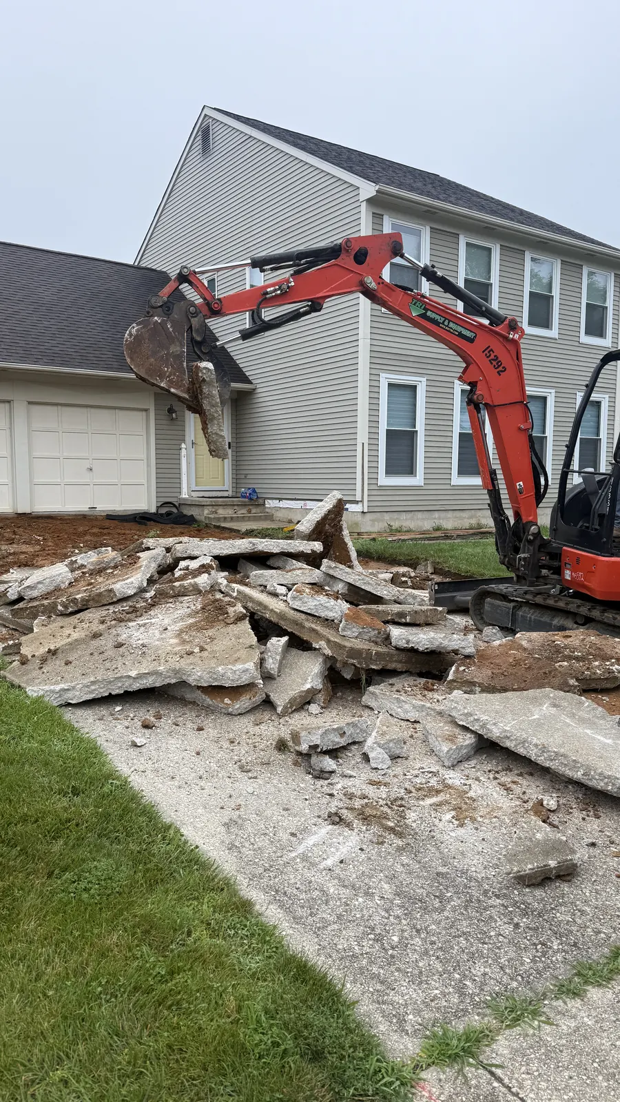 Excavator removing broken concrete during a demolition job in New Castle County, DE