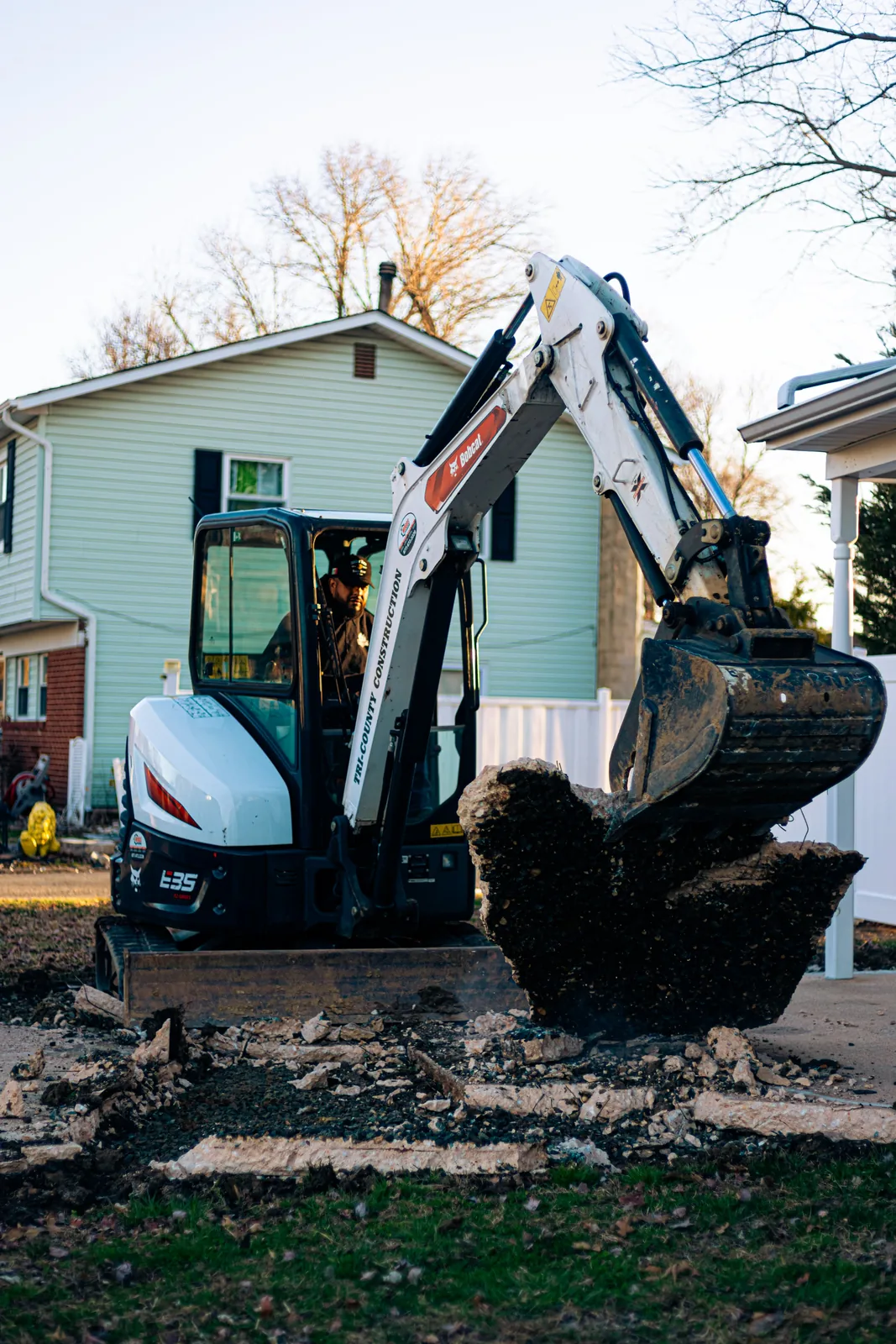 Excavator removing old concrete during demolition in New Castle County, DE