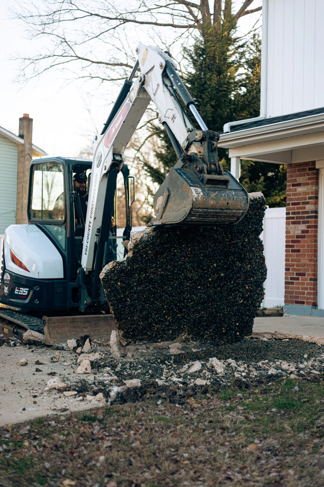 Excavator removing dirt during concrete site work in New Castle County, DE