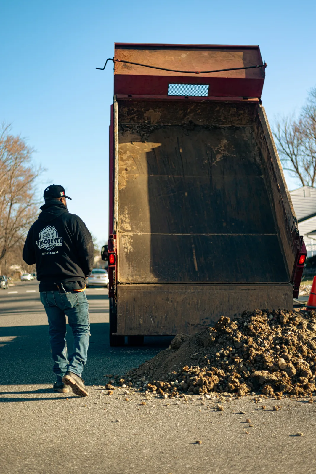 Dump truck unloading material during excavation in New Castle County, DE