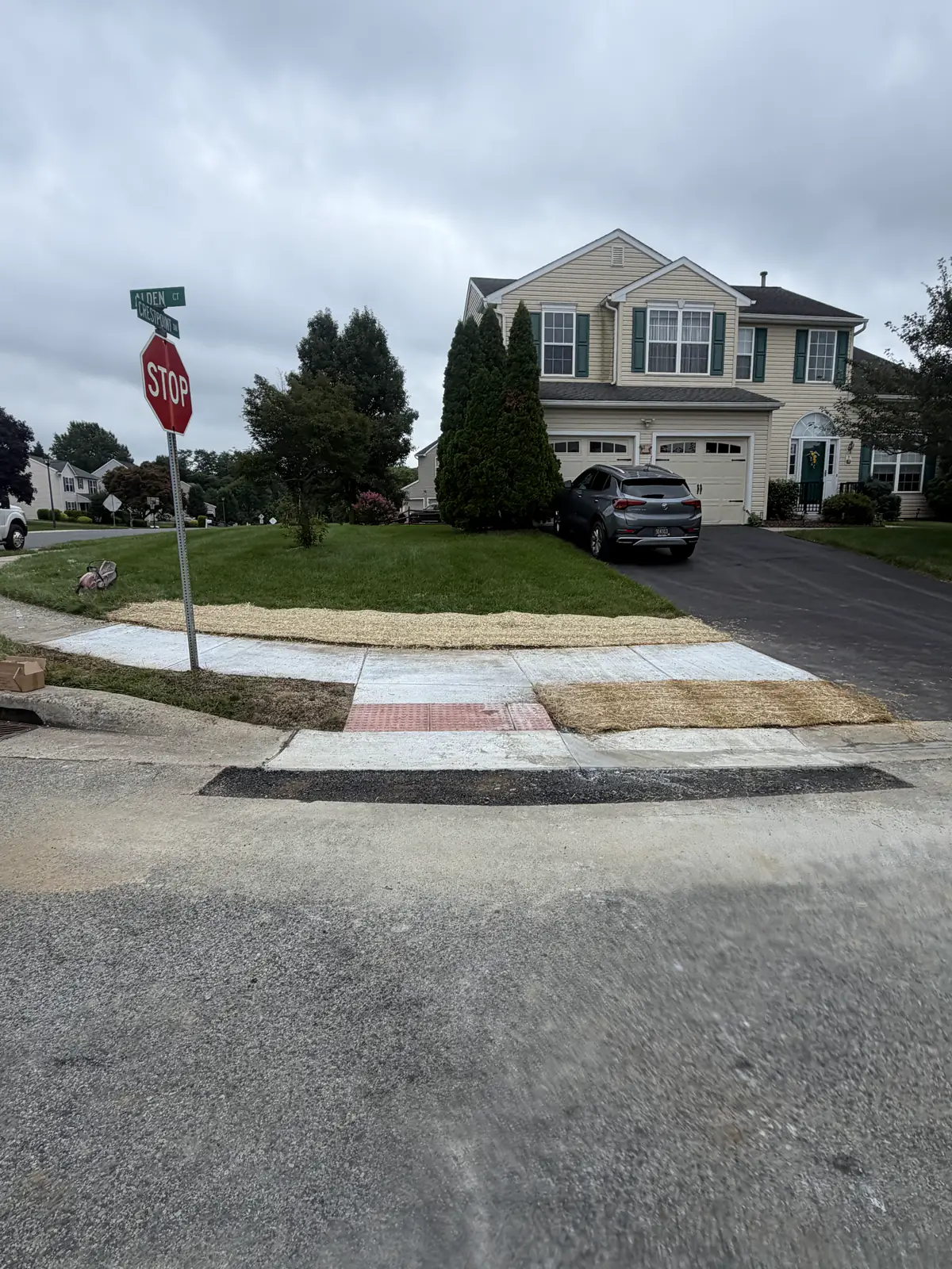 Completed ADA corner ramp and sidewalk at a stop-sign intersection in New Castle County, DE