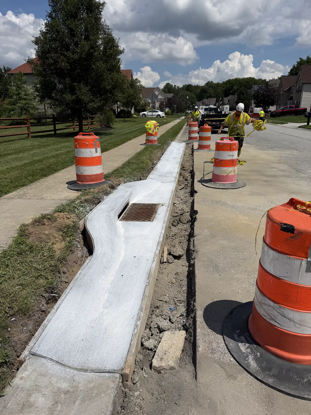 Tri-County Construction crew forming and finishing a new curb and gutter run with a storm inlet on a New Castle County, DE subdivision street