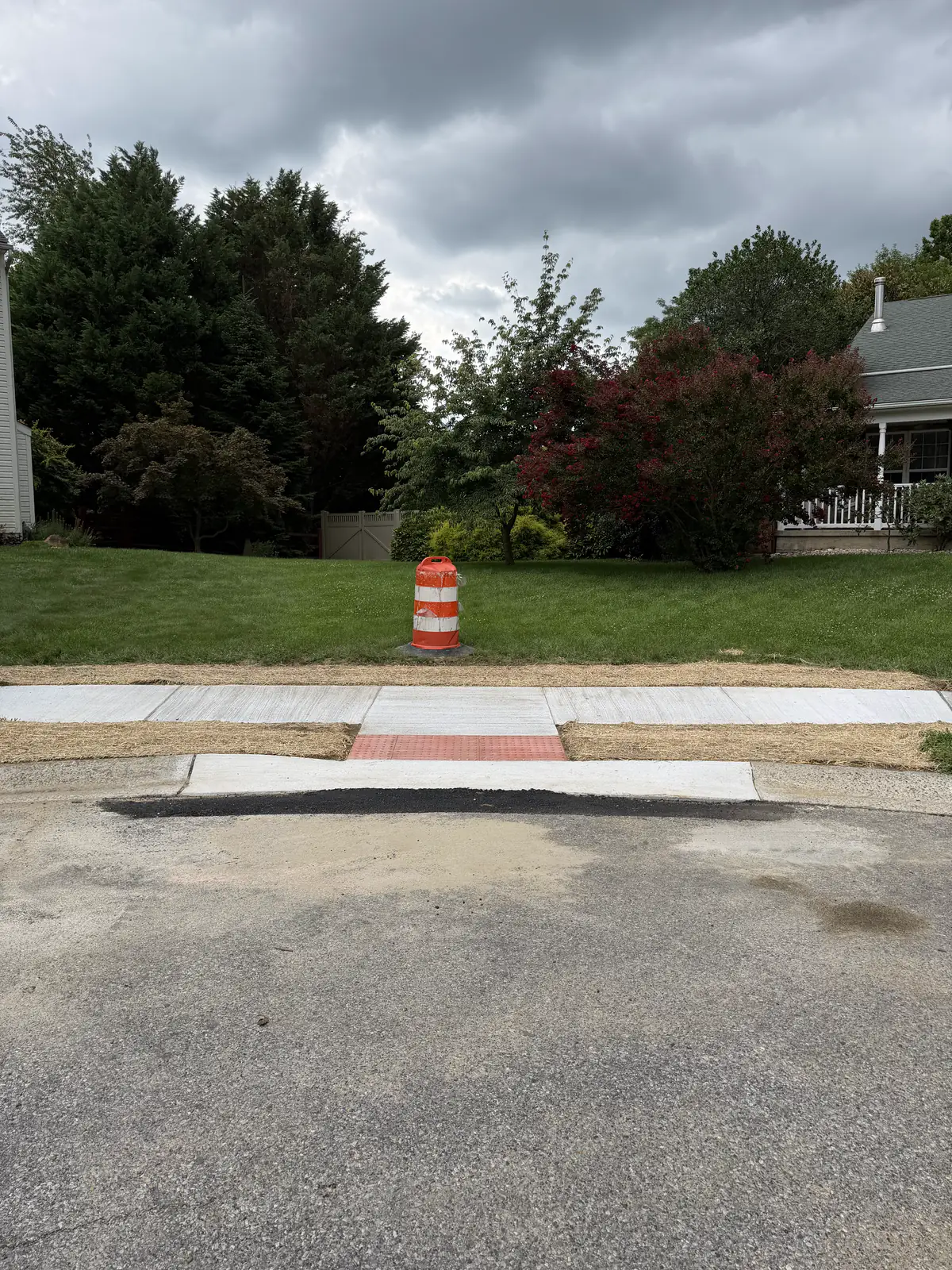 New public sidewalk and ADA ramp at a street crossing under traffic control in New Castle County, DE