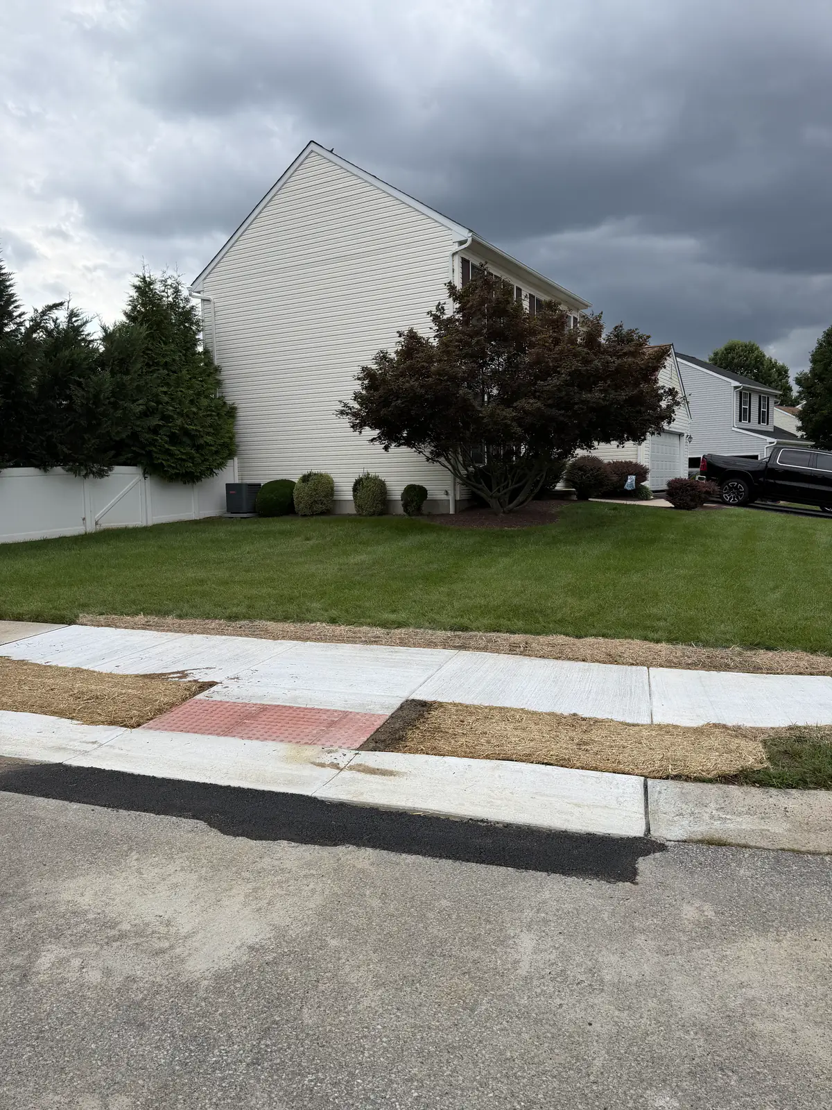 Completed public sidewalk with ADA detectable warning pad and restored seeding in New Castle County, DE