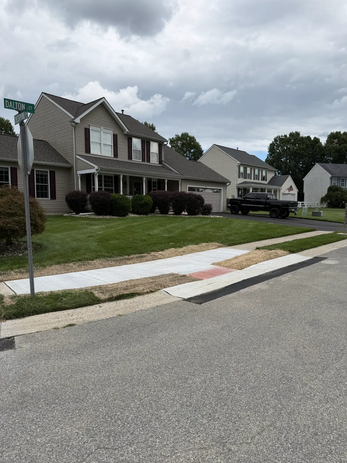 Completed sidewalk and ADA curb ramp along a residential subdivision street in New Castle County, DE
