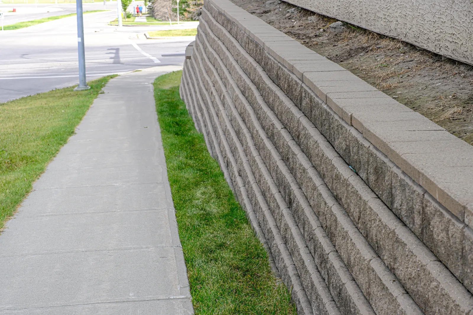 Concrete block retaining wall protecting a residential slope from erosion