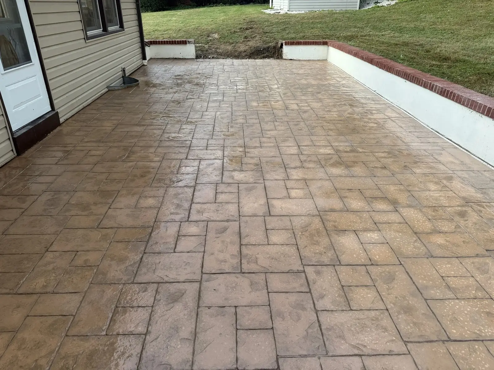 Stamped concrete patio with brick edging in Delaware