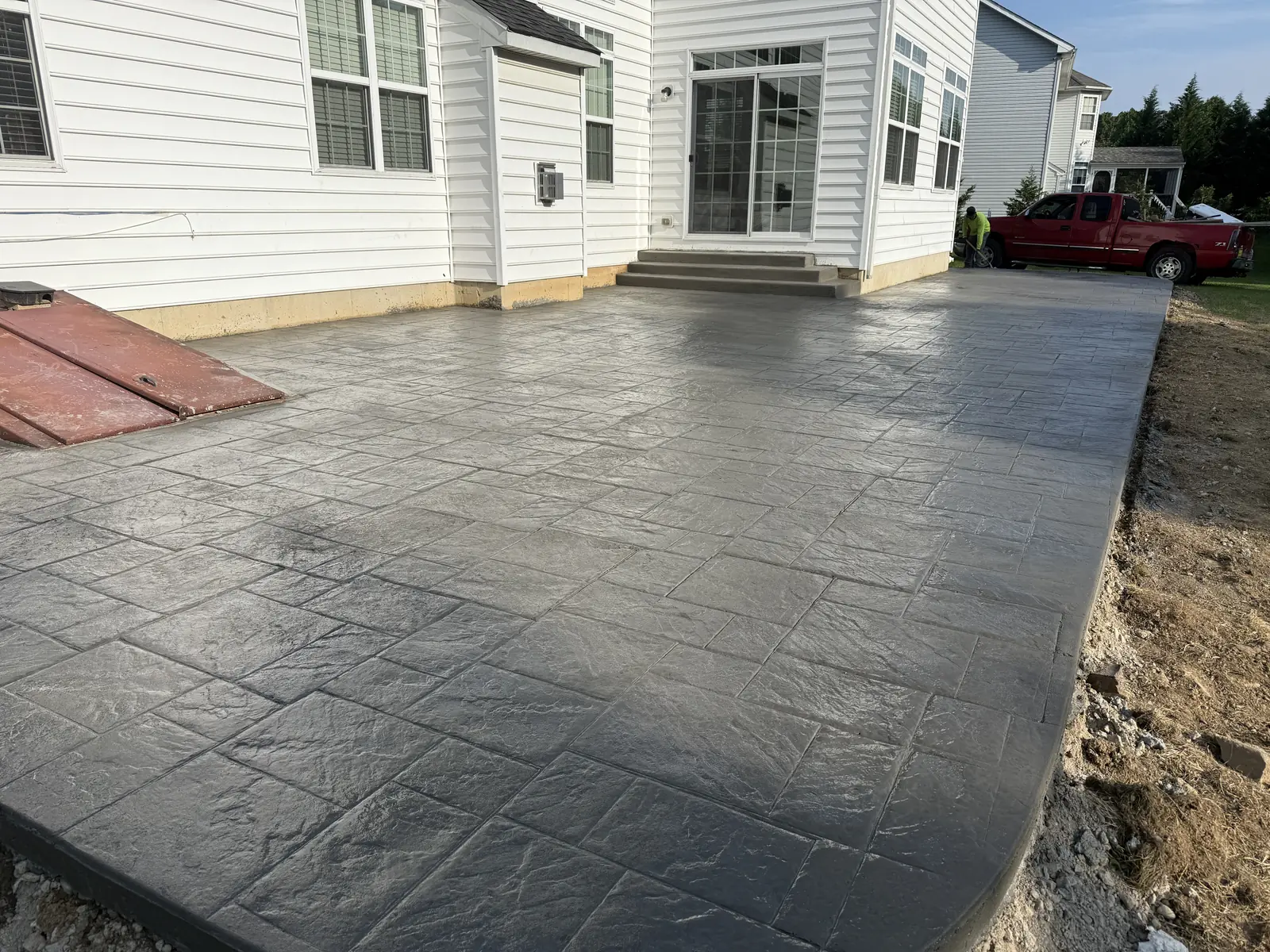 Dark stamped concrete patio with decorative finish in New Castle County, DE