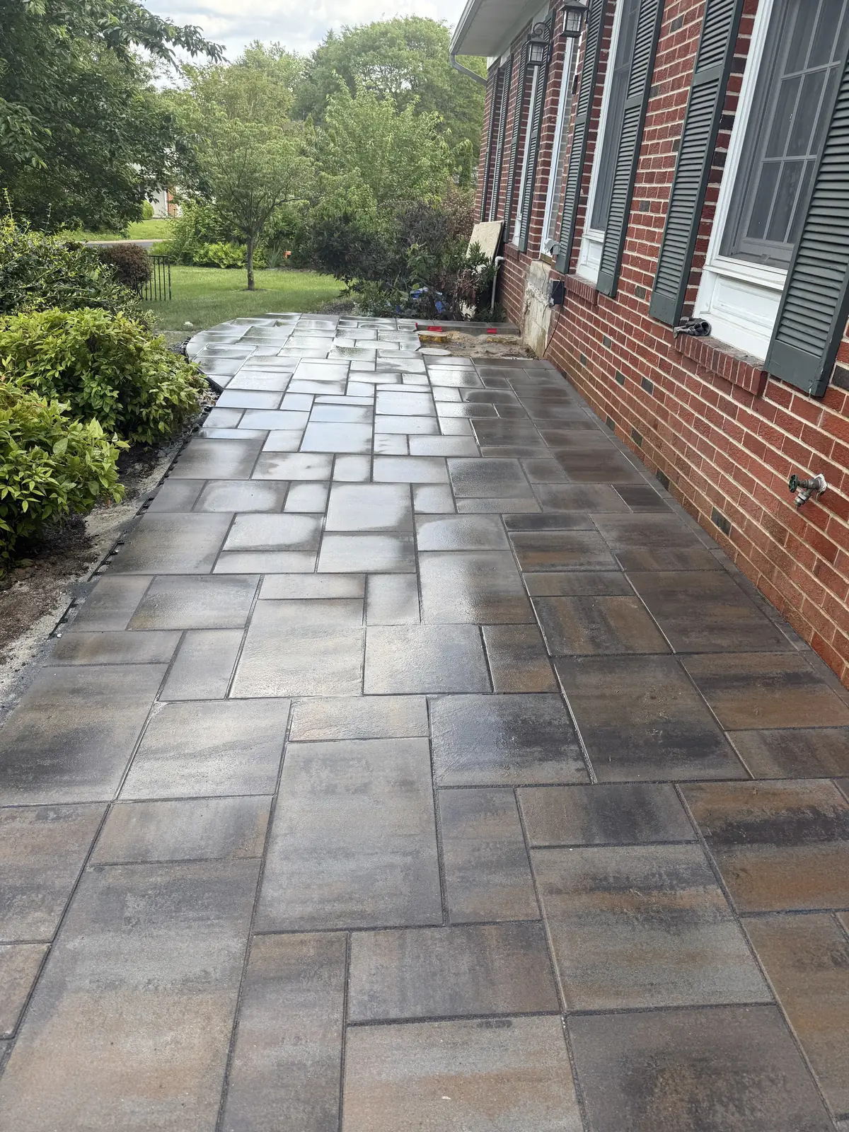 Stamped concrete patio with paver pattern in a New Castle County, DE backyard