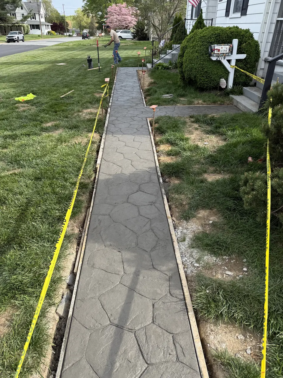 Stamped concrete walkway leading past a mailbox in New Castle, DE